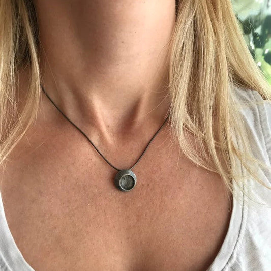 A tiny oxidised silver pendant from Hannah Souter Handmade Jewellery.